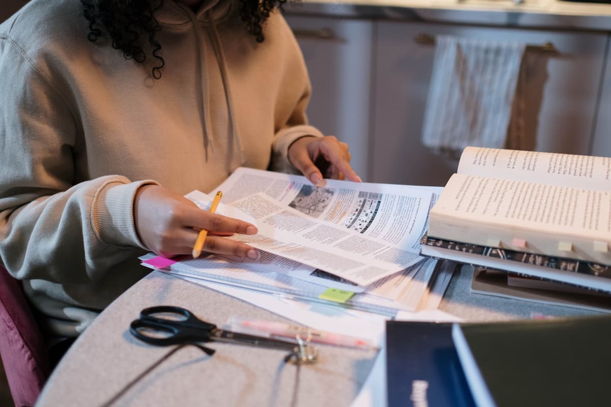 Student studying with textbooks and notes